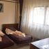 Magic Club, Bușteni: twin beds in a guest room with a window and sheer curtains