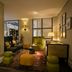 The Nikolai Hamburg lounge in Hamburg with armchairs, ottomans, and a patterned rug