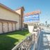 Industry Inn & Suites in La Puente exterior with sign, sidewalk, and landscaped lawn