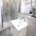 De La Pommeraie, Le Mans: modern bathroom with walk-in shower, sink, and wall-mounted hair dryer