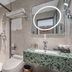 24k International Hotel People's Square in Shanghai bathroom with walk-in shower, toilet, and green mosaic sink vanity