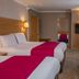 Best Western Heath Court Hotel Newmarket guest room with two beds, desk, chair, wall TV and mirror