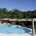 Magic Oceans Dive Resort in Anda: tropical outdoor pool with thatched cabanas and lush greenery