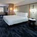 Fairfield by Marriott Inn & Suites Seattle Sea-Tac Airport guest room with king bed and seating area