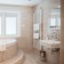 De Lunterse Boer in Lunteren bathroom with soaking tub, window, sink and heated towel rail