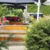 Hotel de Stoppelberg in Beekbergen outdoor lounge with umbrella, seating, and lush garden greenery