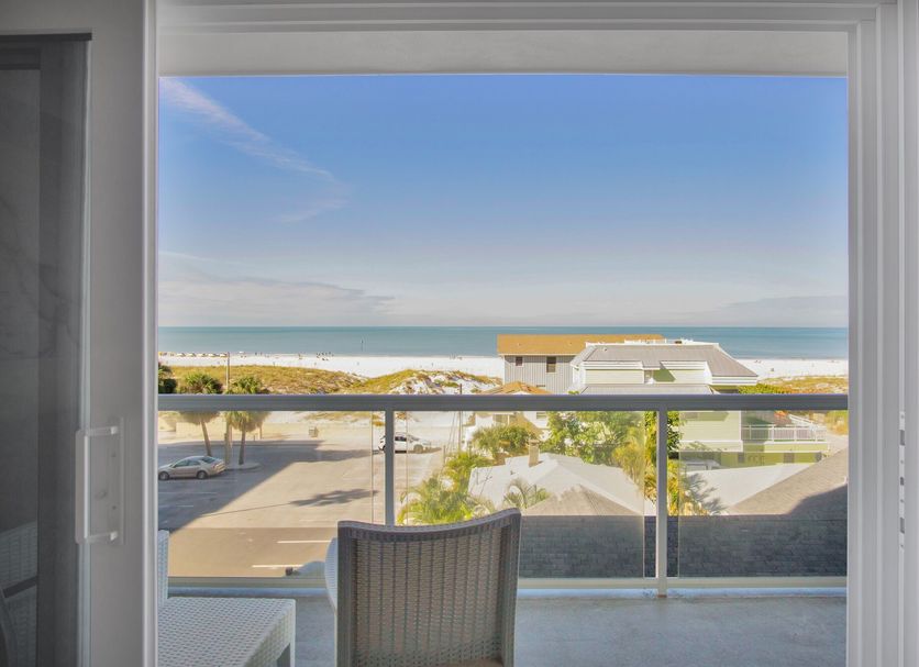 The Avalon Club in Clearwater Beach balcony view with ocean, beachfront buildings, and clear blue sky