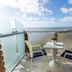 Smy Aran Blu Roma Mare balcony with table and chairs overlooking the sea in Lido di Ostia