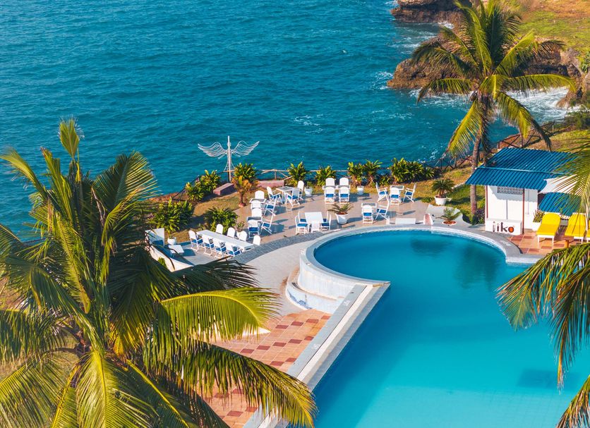 Golden Tulip Dar Es Salaam pool terrace with ocean views and palm trees in Dar Es Salaam