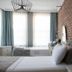 Luna Boutique Hotel Antalya room with brick accent wall, twin beds, tall windows and chandelier