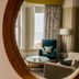 The Brudenell Aldeburgh room with sea view, teal armchair and round mirror in Ipswich