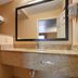 Quality Inn & Suites Williamsport bathroom with tub-shower, toilet, and granite vanity with mirror