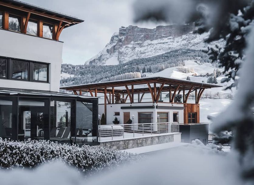 Soleil Alpine Lifestyle Hotel in Badia/Abtei with snowy mountain views and modern alpine buildings