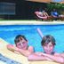 Geraldton's Ocean West pool with children resting on the edge and guests on loungers in Geraldton