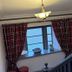 St Olaf Golf Hotel in Peterhead stair landing with plaid curtains, window seat and vintage mirror