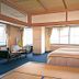 Yamadaya Hotel in Fujikawaguchiko guest room with twin beds, desk, and large windows