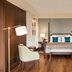 The Oberoi New Delhi guest room with king bed, desk, armchair, and TV in New Delhi