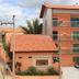 Pousada D' Areia in Barreirinhas, orange hotel building with balconies and tiled roofs