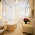 Bathroom at Hotel Del Golfo in Finale Ligure with soaking tub, vessel sink, and window light