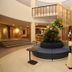 Lobby atrium at Best Western Plus Hotel Terraza in San Salvador with floral centerpiece and staircase