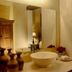 Las Iglesias Antigua bathroom vanity with vessel sink, mirror, flowers and warm beige walls