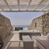 Balius Mykonos in Mykonos, stone terrace with hot tub, lounge bed and sea view
