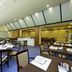 Mercure Reggio Emilia Centro Astoria dining room with tables set under skylights in Reggio nell'Emilia