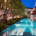 Centara Anda Dhevi Resort & Spa Krabi in Ao Nang: tropical pool with pavilion and lounge chairs at dusk