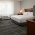 TownePlace Suites by Marriott San Jose Campbell guest room with king bed, sofa, desk and TV