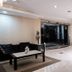 Hotel Premiere in Giugliano in Campania lobby with black seating, coffee table, and glass entrance doors