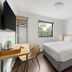Yha Brisbane City room with double bed, desk, chair, wardrobe and window in Brisbane