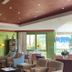 Le Manoir Au Lac in Gérardmer lounge with fireplace, patterned chairs, and lake-facing windows