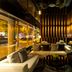 Quentin Boutique Hotel Berlin lobby lounge with curved seating, warm wood walls and city-view windows