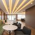 Sandman Signature Ottawa Airport Hotel in Ottawa lobby with green sofa, round tables and lounge seating