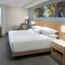 Delta Hotels by Marriott Seattle Everett guest room with king bed, TV, desk and armchair