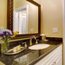 Wayside Inn Carmel-by-the-Sea bathroom vanity with granite counter, sink, mirror and flowers