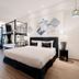 Sabai Mansion Pool & Spa in Krabi guest room with bunk beds, king bed and sliding glass doors to balcony