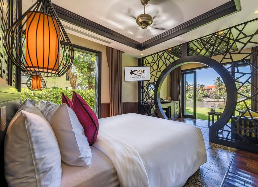 Koi Resort and Spa Hoi An guest room with garden view and sliding glass doors in Hoi An
