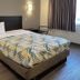 Motel 6-Joliet, IL - Chicago - I-55 guest room with bed, nightstands and window curtains