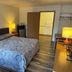 Lakeside Motel Wisconsin Dells room with queen bed, desk, lamps and open door to bathroom