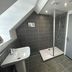 The Stag Rooms Alcester bathroom with walk-in shower, pedestal sink and sloped ceiling