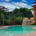 Cabinas La Catarata in La Fortuna: tropical outdoor pool with rock waterfall and lush garden setting