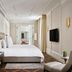 Rosewood Vienna hotel room with king bed, wall-mounted TV, and elegant classic decor in Vienna