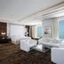 Hilton Dubai The Walk suite with white seating and panoramic sea view in Dubai