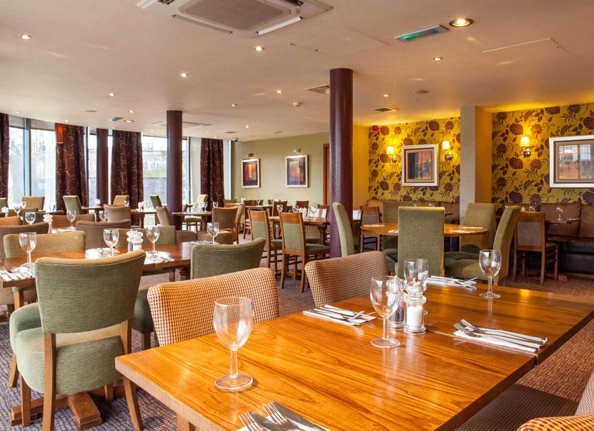 Premier Inn Nottingham Arena - London Road restaurant with wooden tables and upholstered chairs in Nottingham