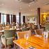 Premier Inn Nottingham Arena - London Road restaurant with wooden tables and upholstered chairs in Nottingham