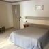 Hotel Le Centre in Brides-les-Bains guest room with double bed, bedside tables and chair