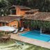 Pousada Terra Madre in Ilhabela with outdoor pool, lounge chairs, and leafy courtyard