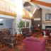 Americas Best Value Inn Annandale lobby with stone fireplace, vaulted ceiling, and patterned seating area
