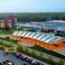 Four Winds Casino Resort in New Buffalo with a covered entrance, parking lot, and wooded horizon